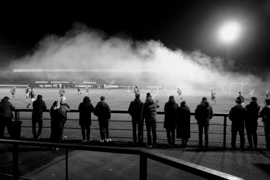 Pyro. Albion Rovers 3-0 Linlithgow Rose, 13.2.24. Cliftonhill Stadium, Coatbridge. Lowland League. Fans let off some pyrotechnics as game kicks off. Iain McLean