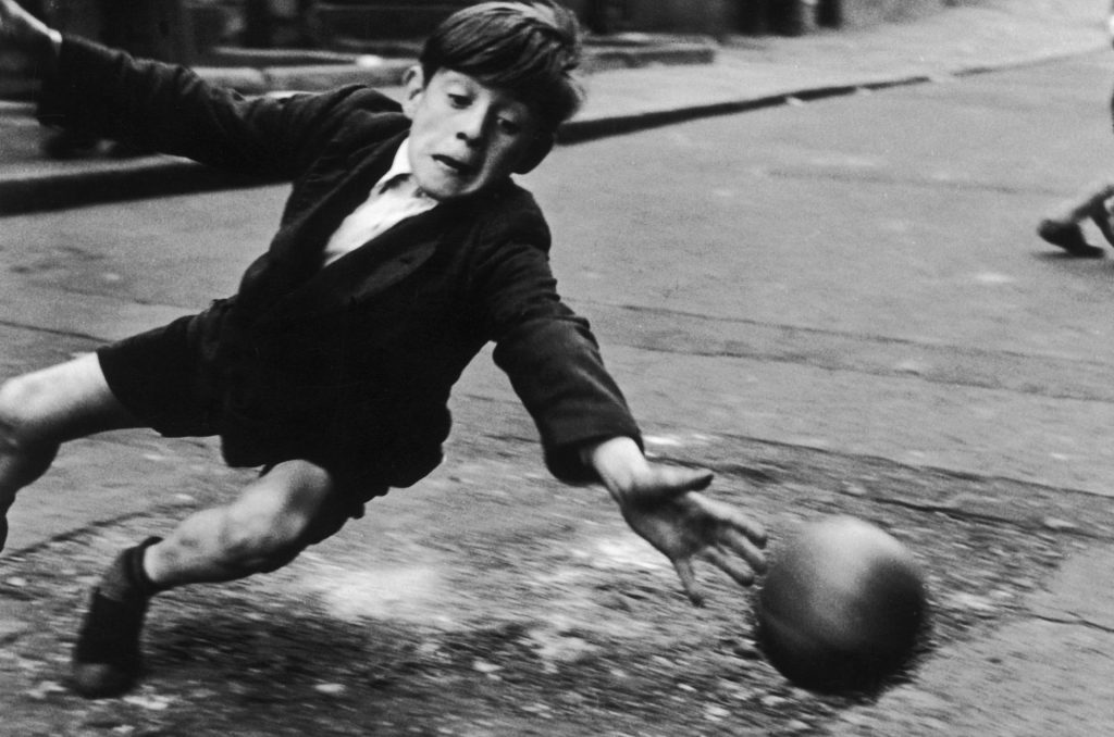 Boy playing street football_ the goalie, 1956. © Roger Mayne Archive _ Mary Evans Picture Library. Courtesy OOF Gallery