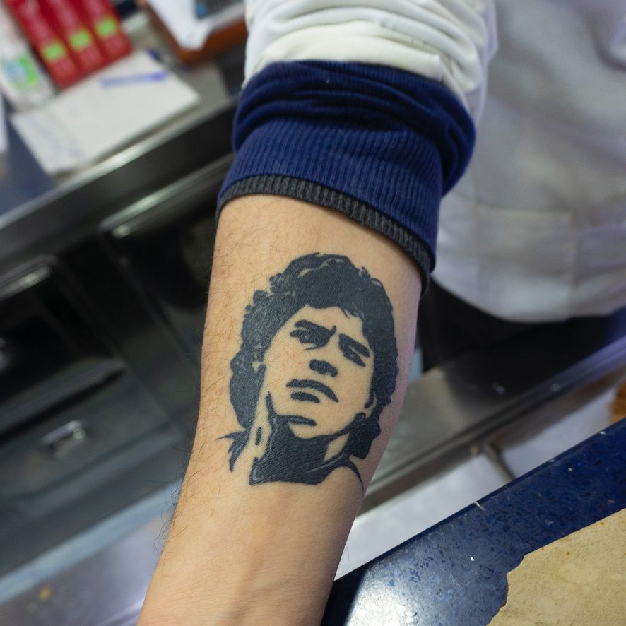 Diego Maradona of Argentina and Napoli, shrine, graffiti, artwork, tattoo, Naples, Italy.